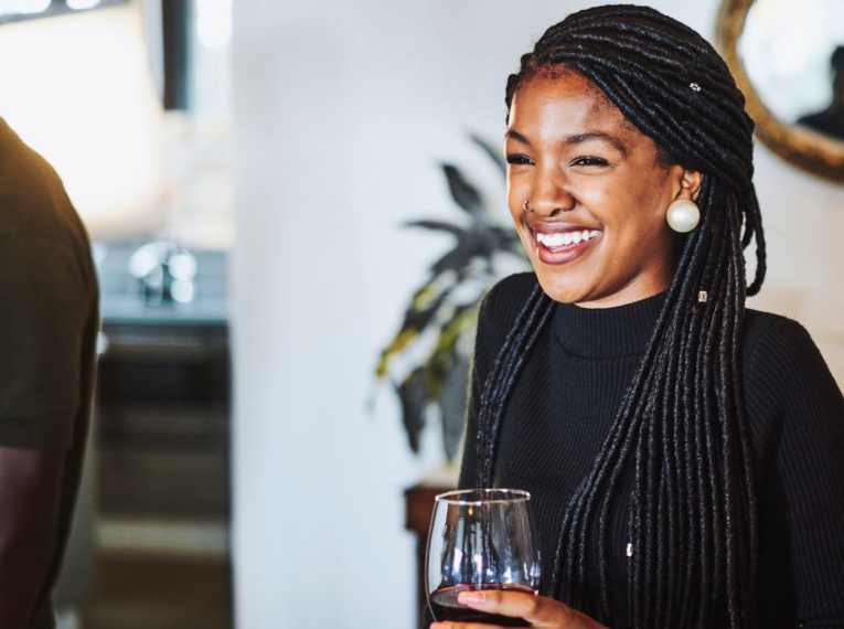 Woman enjoys a glass of wine with friends